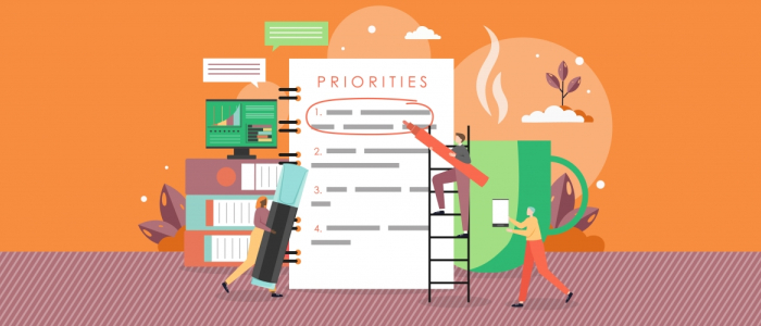 Graphic features three cartoon figures writing on a giant to-do list labeled "Priorities" with giant books, electronics, and a coffee cup in the background.